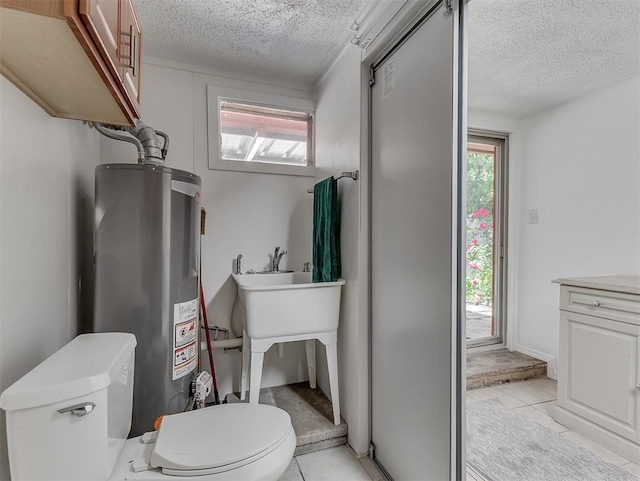 1738 Westchester Dr, Oklahoma City, OK 73120 - bathroom featuring gas water heater, a textured ceiling, toilet, and tile patterned flooring