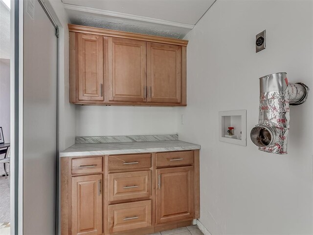 1738 Westchester Dr, Oklahoma City, OK 73120 - clothes washing area with cabinet space, hookup for an electric dryer, washer hookup, and light tile patterned floors