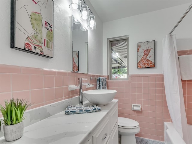 1738 Westchester Dr, Oklahoma City, OK 73120 - full bath with tile walls, vanity, toilet, a wainscoted wall, and shower / bath combo