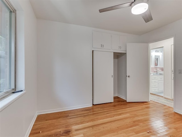 1738 Westchester Dr, Oklahoma City, OK 73120 - unfurnished bedroom with light wood finished floors, a closet, baseboards, ceiling fan, and connected bathroom
