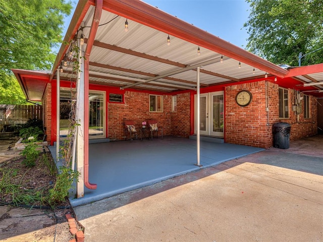1738 Westchester Dr, Oklahoma City, OK 73120 - view of patio / terrace featuring french doors, fence, and an attached carport