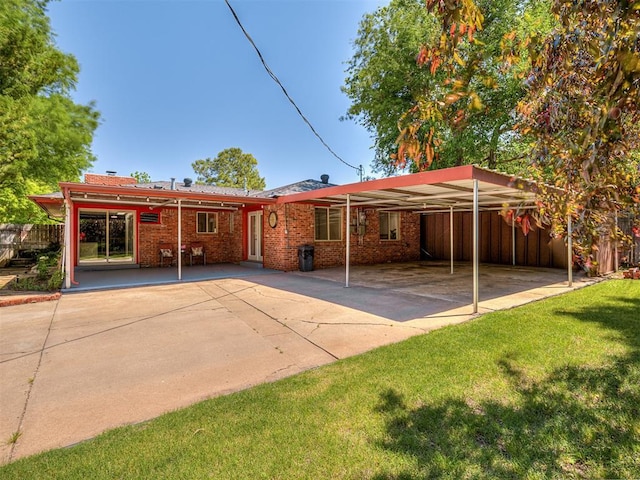 1738 Westchester Dr, Oklahoma City, OK 73120 - back of property with a carport, brick siding, and concrete driveway