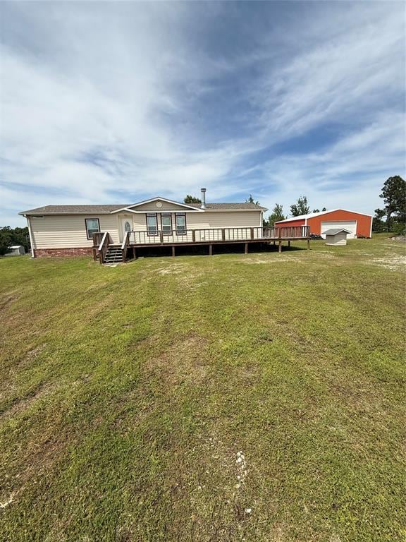106 Sundown Ct, Mcloud, OK 74851 - view of front of house featuring a wooden deck, a front lawn, and a garage