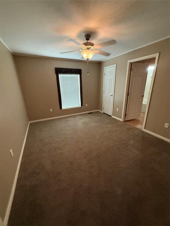 106 Sundown Ct, Mcloud, OK 74851 - unfurnished bedroom with baseboards, ornamental molding, carpet flooring, a closet, and ceiling fan