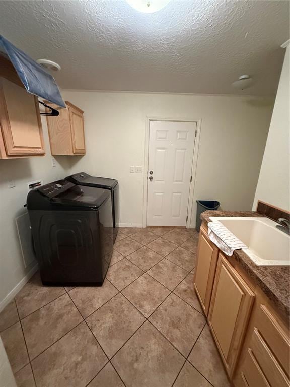 106 Sundown Ct, Mcloud, OK 74851 - laundry area with cabinet space, independent washer and dryer, a textured ceiling, light tile patterned flooring, and baseboards