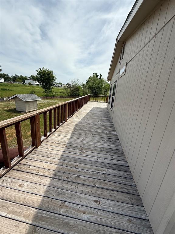 106 Sundown Ct, Mcloud, OK 74851 - deck featuring an outbuilding and a storage unit