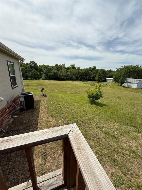 106 Sundown Ct, Mcloud, OK 74851 - view of green lawn featuring cooling unit