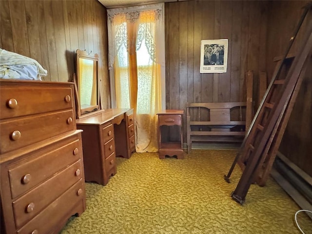living area with wooden walls and light carpet