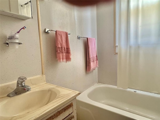 bathroom featuring a tub and vanity