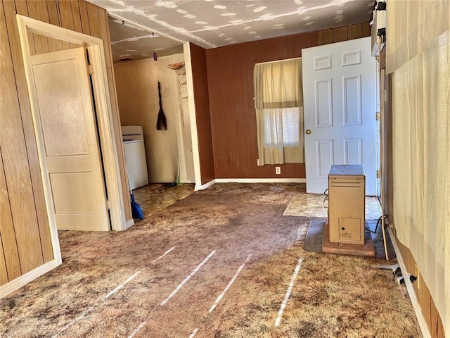 spare room featuring carpet floors and wooden walls