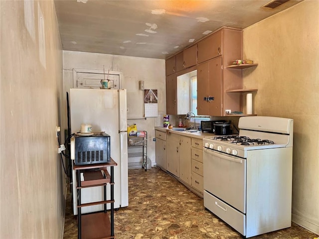 kitchen with white gas stove, a sink, open shelves, light countertops, and fridge