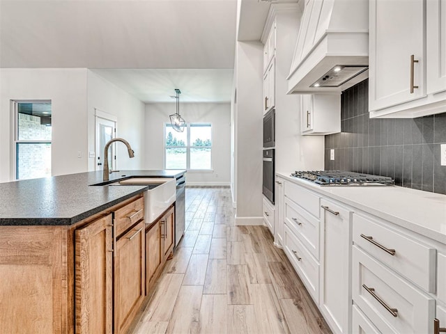 10424 SW 51st St, Mustang, OK 73064 - kitchen featuring custom range hood, a sink, a chandelier, black appliances, and an island with sink