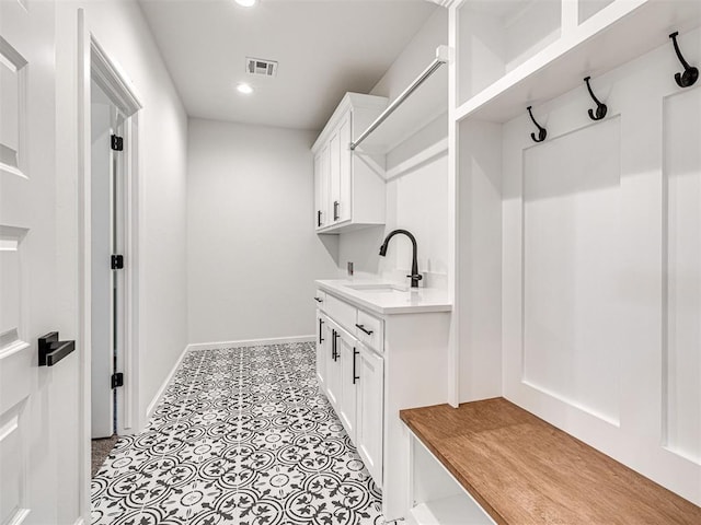 10424 SW 51st St, Mustang, OK 73064 - laundry room with a sink, baseboards, and recessed lighting