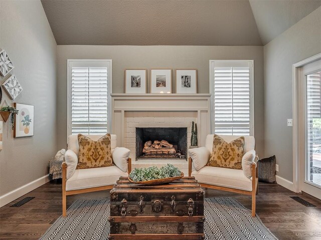 3605 Abbotsford, Norman, OK 73072 - living area with lofted ceiling, dark wood-style flooring, a fireplace, baseboards, and healthy amount of natural light