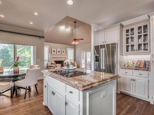 3605 Abbotsford, Norman, OK 73072 - kitchen with black electric cooktop, high quality fridge, dark wood-style flooring, a center island, and glass insert cabinets