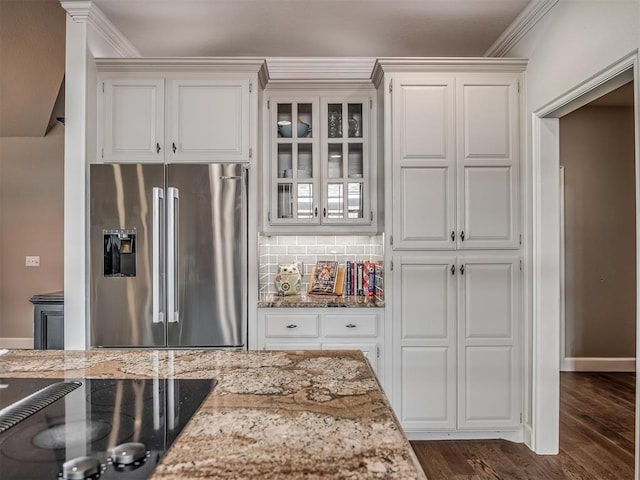 3605 Abbotsford, Norman, OK 73072 - kitchen featuring stainless steel fridge, light stone counters, white cabinetry, glass insert cabinets, and ornamental molding