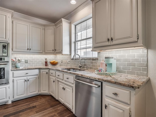 3605 Abbotsford, Norman, OK 73072 - kitchen featuring appliances with stainless steel finishes, a sink, dark wood-style flooring, decorative backsplash, and light stone counters