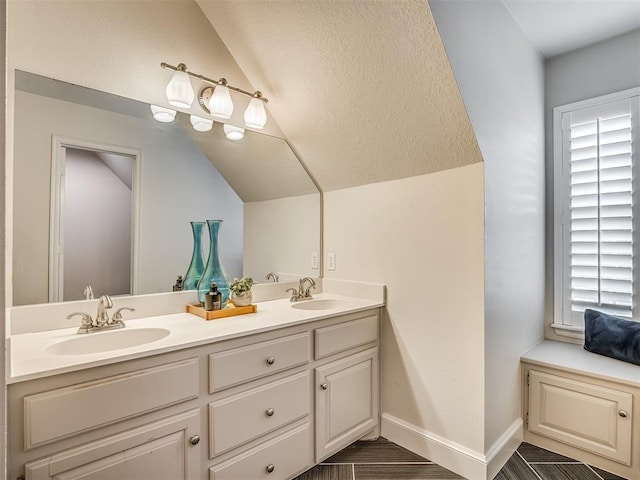 3605 Abbotsford, Norman, OK 73072 - bathroom featuring vaulted ceiling, double vanity, and baseboards