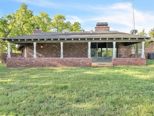 100 Maple Ln, Chickasha, OK 73018 - back of house featuring a chimney, a yard, and brick siding