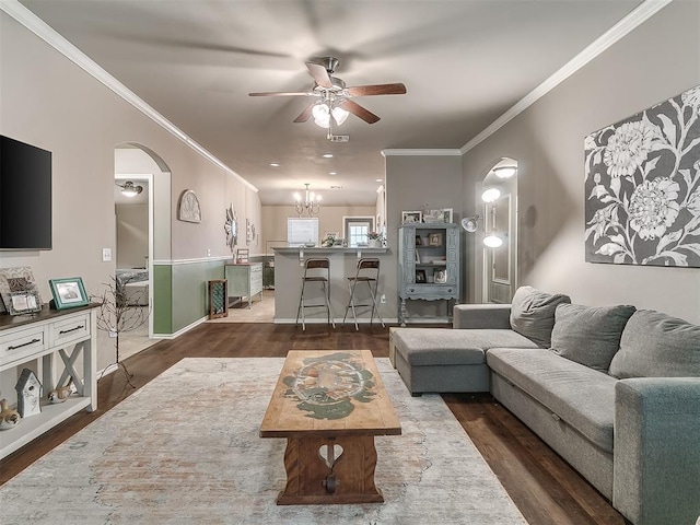 2536 Canyon Creek Dr, Yukon, OK 73099 - living room featuring ceiling fan, wood finished floors, arched walkways, crown molding, and a chandelier