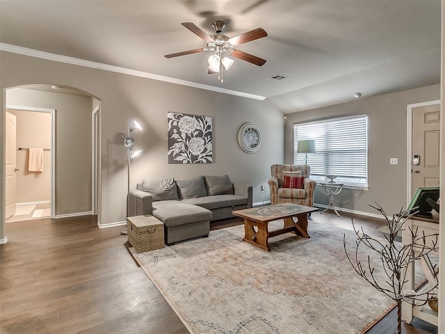 2536 Canyon Creek Dr, Yukon, OK 73099 - living room with arched walkways, ceiling fan, wood finished floors, baseboards, and crown molding