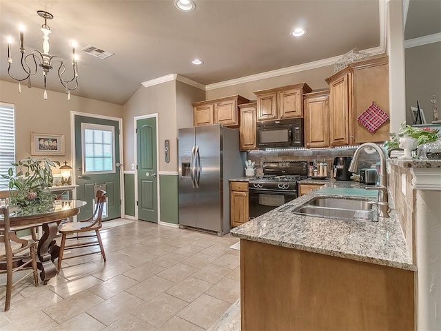 2536 Canyon Creek Dr, Yukon, OK 73099 - kitchen featuring black appliances, a sink, ornamental molding, decorative backsplash, and light stone counters