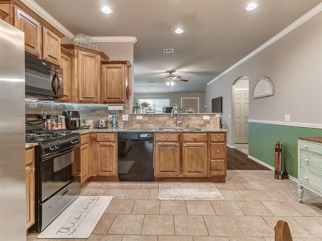 2536 Canyon Creek Dr, Yukon, OK 73099 - kitchen featuring black appliances, a sink, crown molding, ceiling fan, and tasteful backsplash