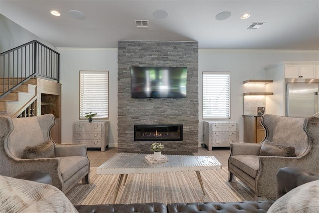 3419 Abby Ln, Newcastle, OK 73065 - living room featuring a stone fireplace, crown molding, wood finished floors, and recessed lighting