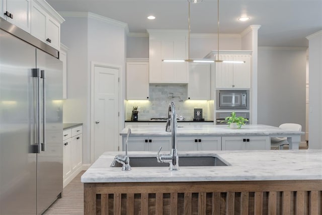 3419 Abby Ln, Newcastle, OK 73065 - kitchen featuring built in appliances, decorative backsplash, white cabinetry, crown molding, and a sink