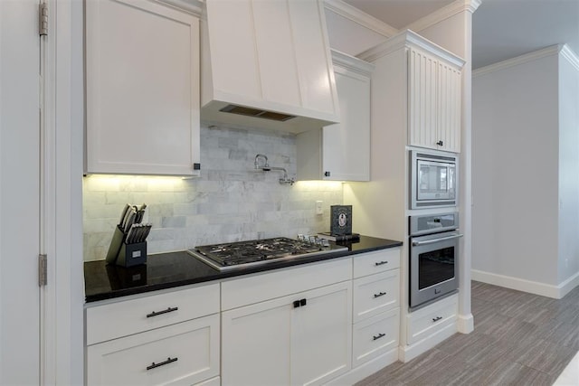 3419 Abby Ln, Newcastle, OK 73065 - kitchen with appliances with stainless steel finishes, custom exhaust hood, dark countertops, decorative backsplash, and crown molding