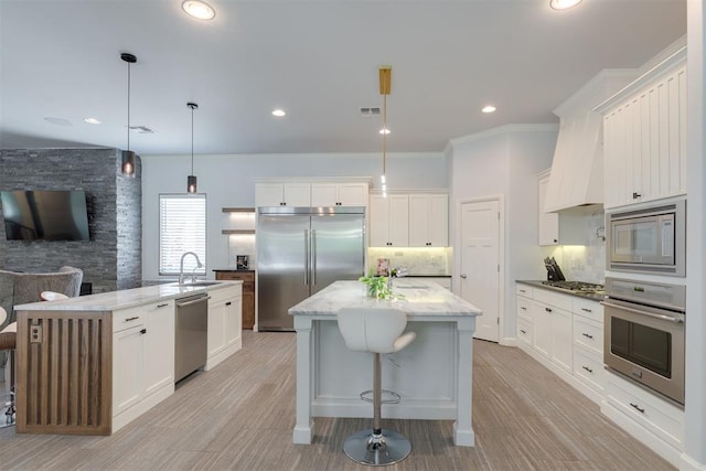 3419 Abby Ln, Newcastle, OK 73065 - kitchen with built in appliances, a center island with sink, a sink, decorative backsplash, and ornamental molding