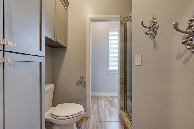 3419 Abby Ln, Newcastle, OK 73065 - full bathroom featuring toilet, a stall shower, baseboards, and wood finished floors
