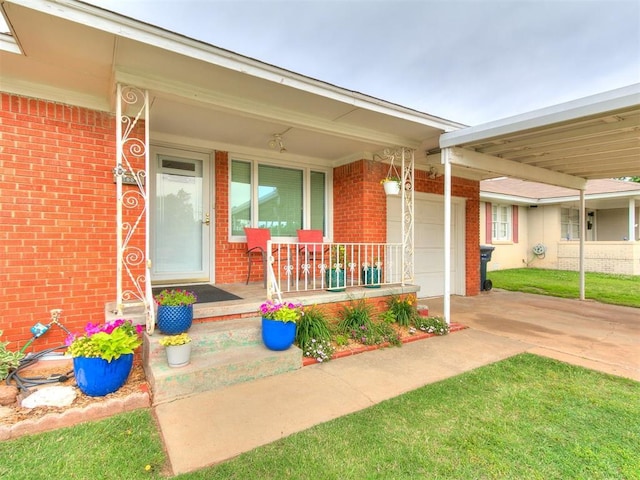 5001 N Independence Ave, Oklahoma City, OK 73112 - view of exterior entry with brick siding, covered porch, driveway, and an attached garage