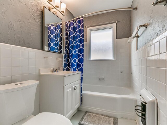 5001 N Independence Ave, Oklahoma City, OK 73112 - full bathroom featuring tile walls, toilet, vanity, wainscoting, and shower / bath combination with curtain