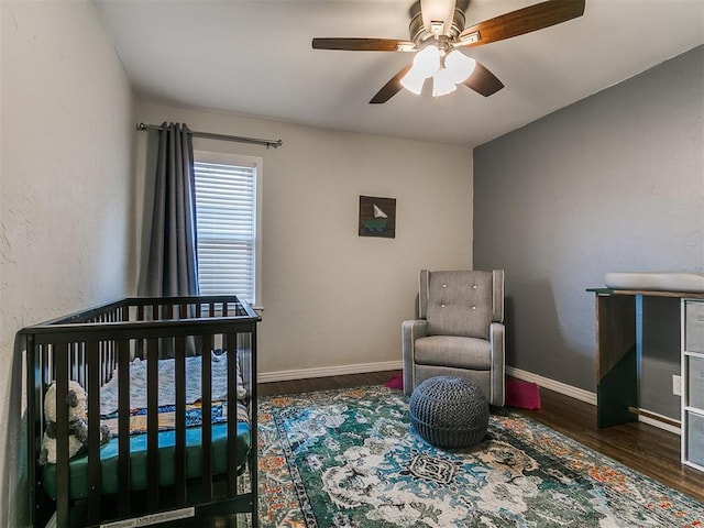 5001 N Independence Ave, Oklahoma City, OK 73112 - bedroom featuring wood finished floors, a nursery area, ceiling fan, and baseboards