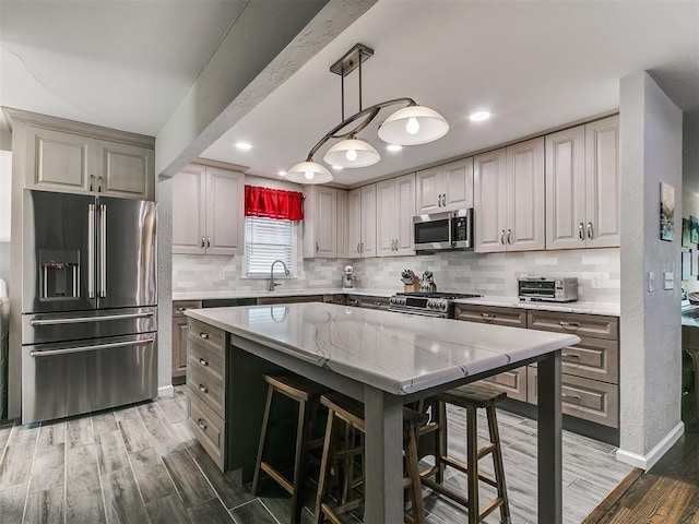 5001 N Independence Ave, Oklahoma City, OK 73112 - kitchen with appliances with stainless steel finishes, backsplash, light stone countertops, light wood finished floors, and recessed lighting