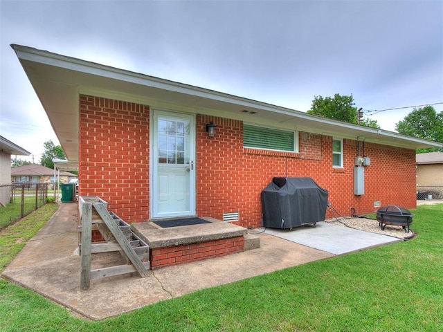 5001 N Independence Ave, Oklahoma City, OK 73112 - back of house with a fire pit, a patio area, brick siding, and crawl space