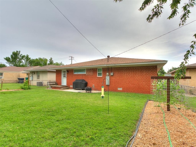 5001 N Independence Ave, Oklahoma City, OK 73112 - back of property with central air condition unit, brick siding, a vegetable garden, and a patio area