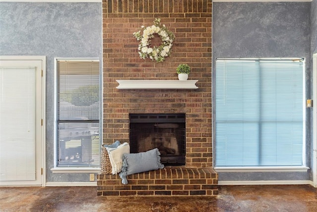 4917 Byron Cir, Yukon, OK 73099 - unfurnished living room with baseboards, a brick fireplace, and plenty of natural light