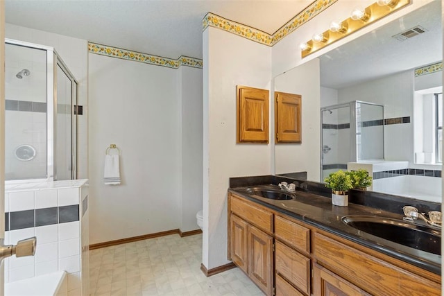 4917 Byron Cir, Yukon, OK 73099 - full bath with a stall shower, a garden tub, double vanity, toilet, and tile patterned floors