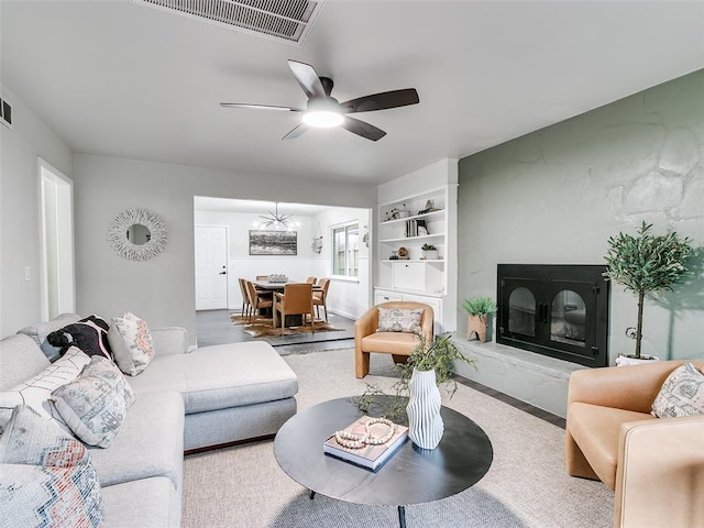 3325 NW 65th St, Oklahoma City, OK 73116 - living area featuring a ceiling fan, a fireplace, and built in features