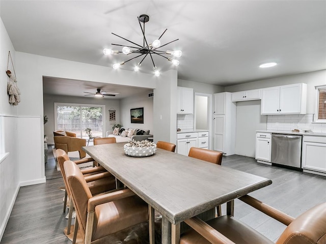 3325 NW 65th St, Oklahoma City, OK 73116 - dining area with dark wood finished floors, a chandelier, a ceiling fan, and baseboards