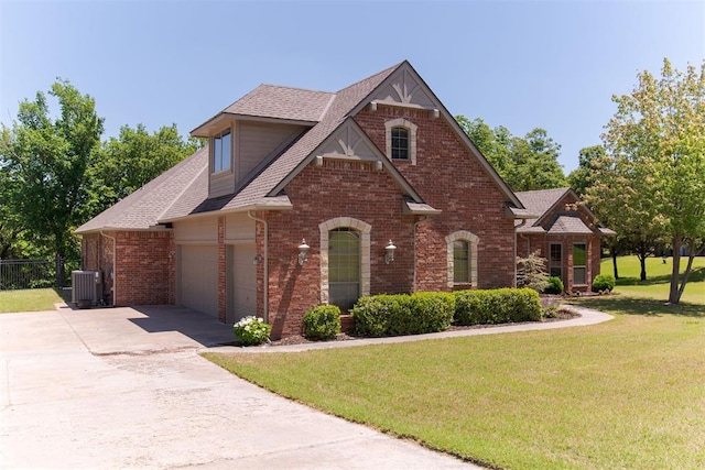 view of front of home featuring brick siding, driveway, a garage, and roof with shingles