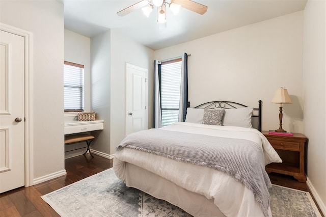 bedroom with wood finished floors, multiple windows, baseboards, and ceiling fan
