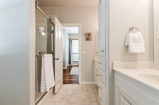 bathroom featuring vanity, a shower stall, and tile patterned floors