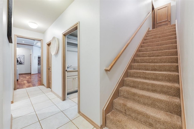 stairs featuring tile patterned floors and baseboards