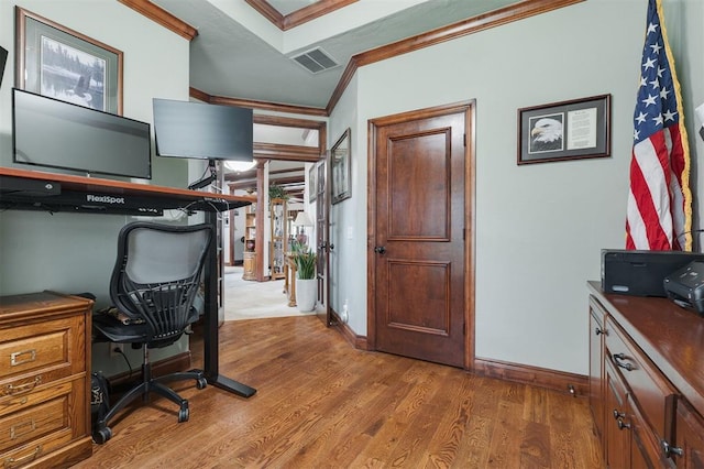 home office with ornamental molding, wood finished floors, and baseboards