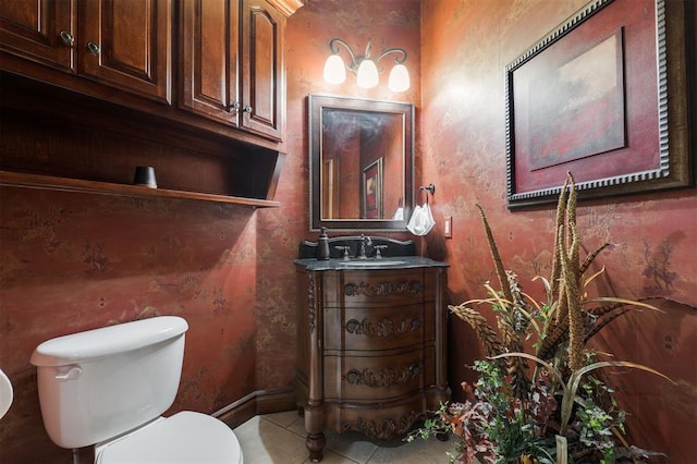 half bathroom with toilet, vanity, and tile patterned flooring