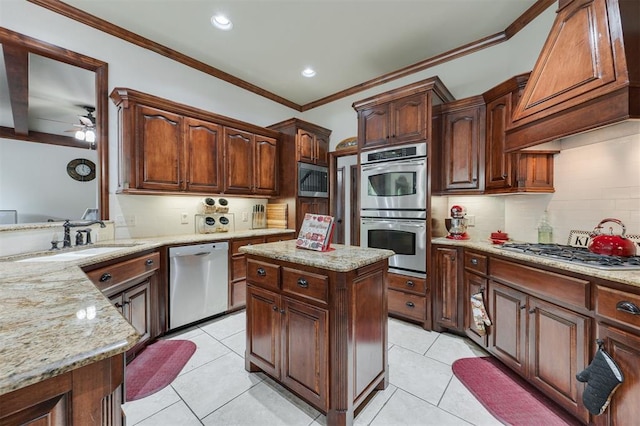kitchen with appliances with stainless steel finishes, a sink, backsplash, custom exhaust hood, and light stone countertops