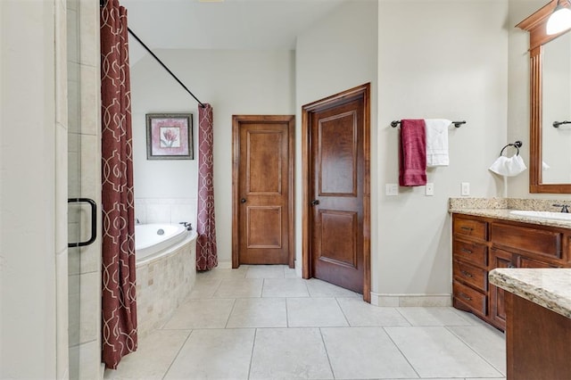 full bath with tile patterned flooring, tiled tub, a shower, and vanity